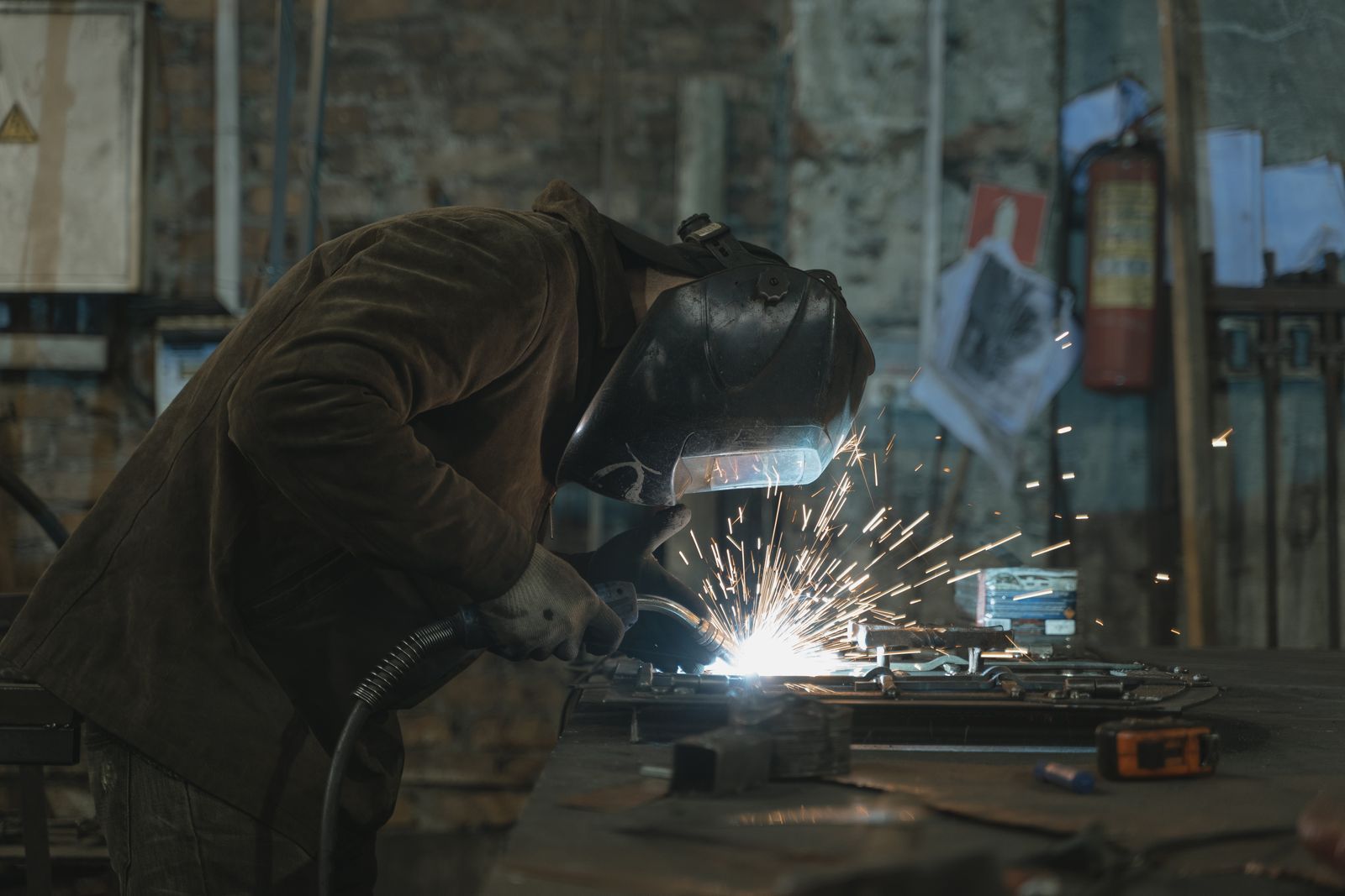A worker at a machine on a shop floor